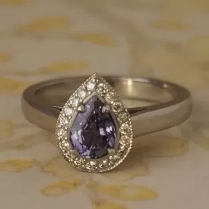 Apollo - PLT .87ct Steel Blue Pear Sapphire Cluster Ring with .19ct TDW D-F VS/Si Diamond Halo