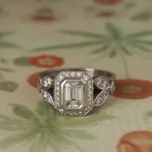 Trellis - PLT .75ct D Si2 Emerald Cut Cluster Ring with Round and Carre .54ct TDW D-F VS and Petal Details Size N