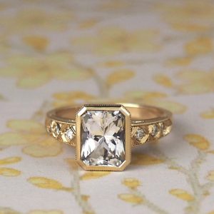 Paloma - 9YG 2.27ct White Radiant Danburite Solitaire Ring with Hand Engraved Detail set with .146ct TDW Diamonds Size N 1/2