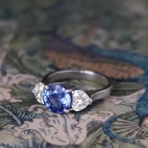 Je t'aime - PLT 3.26ct Blue Round Sapphire (Cert) Three Stone Ring with 1.45ct TDW Brilliant Heart Cut Diamond Shoulders Size P1/2
