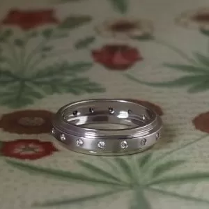 Stephanie - 18WG .16ct TDW Gypsy Set 5mm Wide Stepped Mixed Finish Band Size N