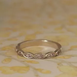 Margi - 9WG .25ct TW Pink Spinels Grain Set in Marquise Shaped Band with Milgrain Edge Detail
